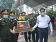 Centre: Inhumation des restes d'une centaine de soldats et experts vietnamiens tombés au Laos