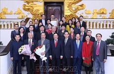 Le vice-PM et ministre des AE Pham Binh Minh reçoit des délégués du Forum populaire Vietnam-Chine