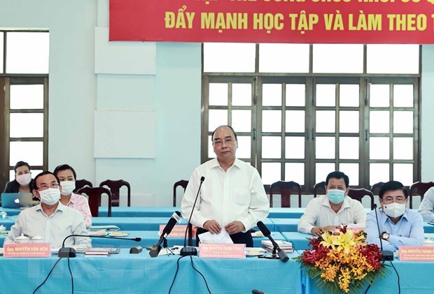 Le president Nguyen Xuan Phuc en tournee dans les districts de Cu Chi et Hoc Mon hinh anh 1