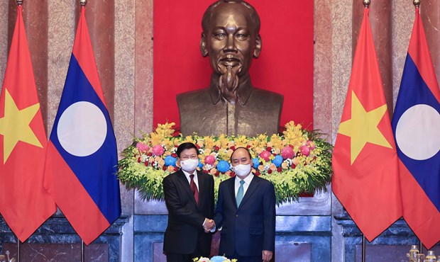 Entrevue entre le president vietnamien et le SG du Parti et president lao hinh anh 1