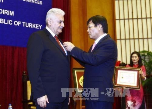Insigne «Pour la cause des sciences sociales du Vietnam» au Premier ministre turc hinh anh 1
