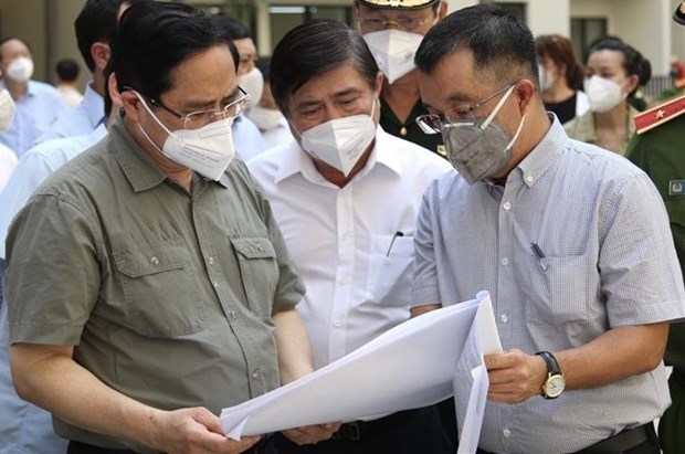 Le PM travaille avec les autorites de HCM-Ville sur des mesures de contenir le coronavirus hinh anh 1