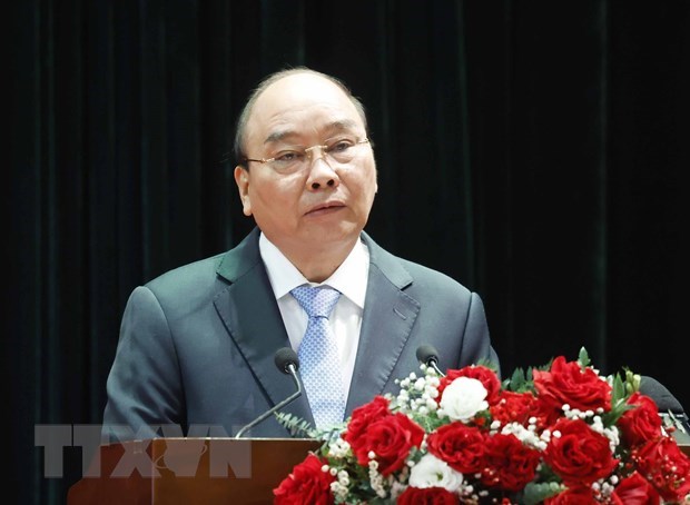 Le president Nguyen Xuan Phuc souligne le role du travail sur la population hinh anh 1